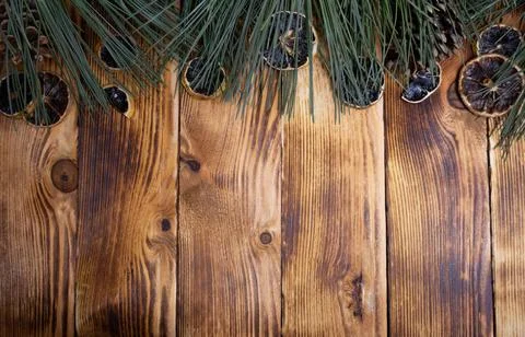 Pine branches and dried oranges on a wood backdrop Christmas background Stock Photos