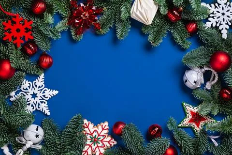 Pine branches, bauble, white and red snowflakes. Stock Photos