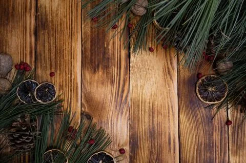 Pine branches cones dried ornaged rosehip and nuts on a wood backdrop Christ Stock Photos
