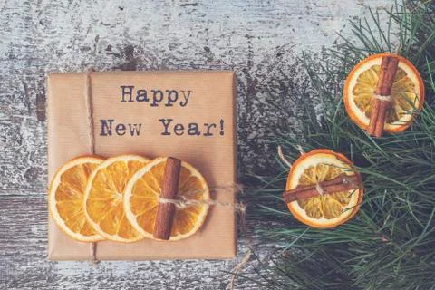 Pine branches, craft gift, dried oranges, cinnamon, top view. Stock Photos