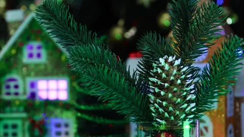 Pine cone and fir tree branches rotating against background of beautiful houses Stock Footage 288095408