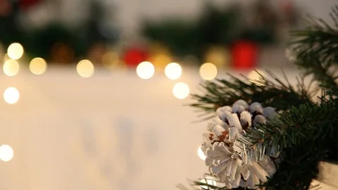 Pine cone on a Christmas tree against the background of a defocused garland Stock Footage 120945510