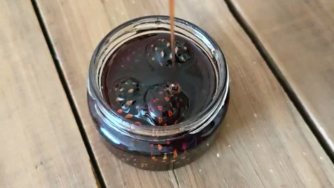 Pine cone honey being poured into a jar Stock Footage 304293211