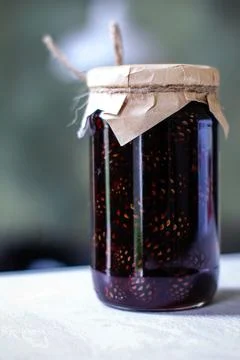 Pine cone jam jar with kraft lid and rope decoration Stock Photos