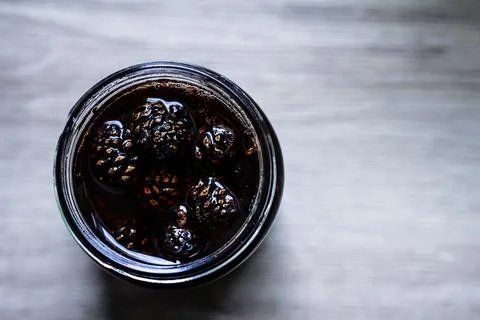 Pine cone jam jar with kraft lid and rope decoration Stock Photos