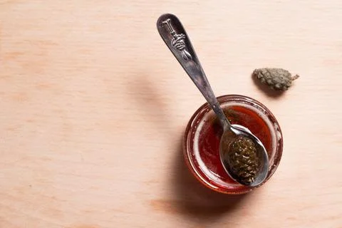 Pine cone jam. Small cones in sweet syrup close-up. Small pine cones in sugar sy Stock Photos