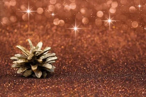 Pine cone on red, brown defocused shiny with stars and glitter, shimmer Stock Photos