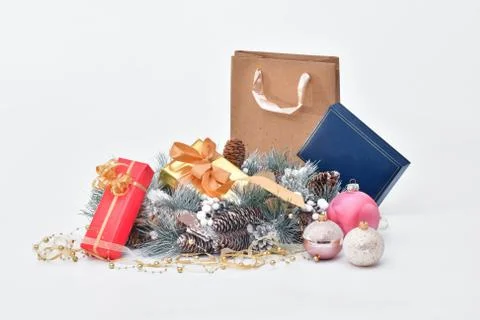 Pine-cone wreath surrounded by wrapped gift boxes, Christmas baubles and a gi Stock Photos