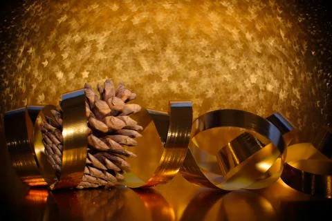 Pine cones on golden background Stock Photos