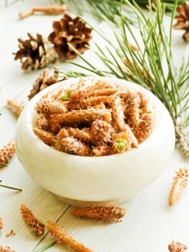 Pine cones in mortar Stock Photos