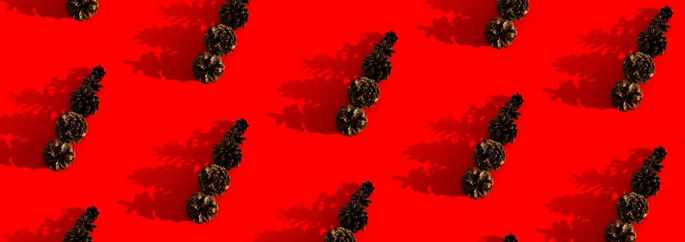 Pine cones on red background pattern. Merry Christmas Creative New Year concept. Stock Photos