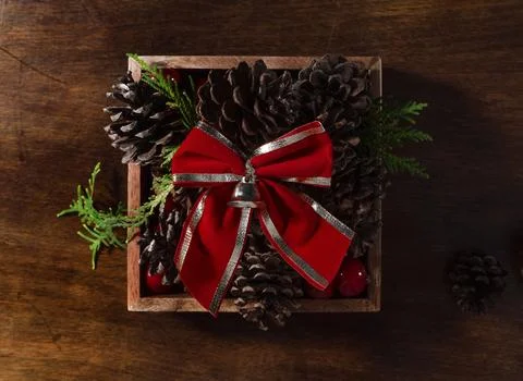 Pine-cones-topped-with-a-red-bow Stock Photos