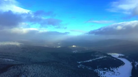 Pine forest, snow, mountains, blue sky, clouds, aerial photography Stock Footage 123757506