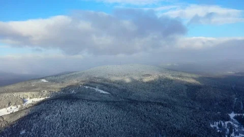 Pine forest, snow, mountains, blue sky, clouds, aerial photography Stock Footage 123757553