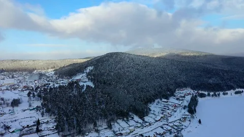 Pine forest, snow, mountains, blue sky, clouds, aerial photography Stock Footage 123757662