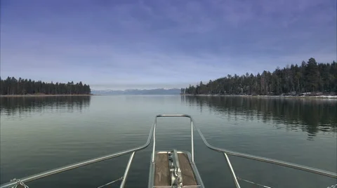 Pine forests reflect onto lake Video stock 986675