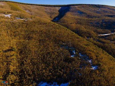 Pine mountains with traces of snow from drone view Stock Photos