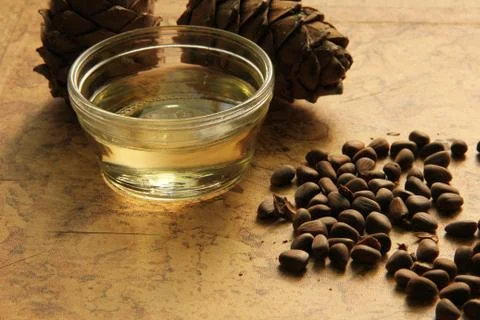 Pine nuts and bottle of essential oil Stock Photos