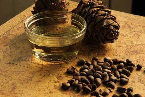 Pine nuts and bottle of essential oil Stock Photos