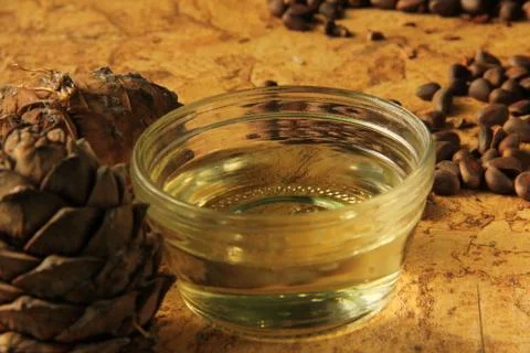 Pine nuts and bottle of essential oil Stock Photos