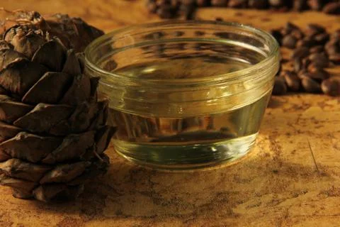 Pine nuts and bottle of essential oil Stock Photos