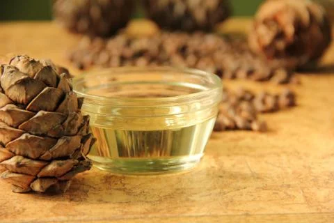 Pine nuts and bottle of essential oil Stock Photos