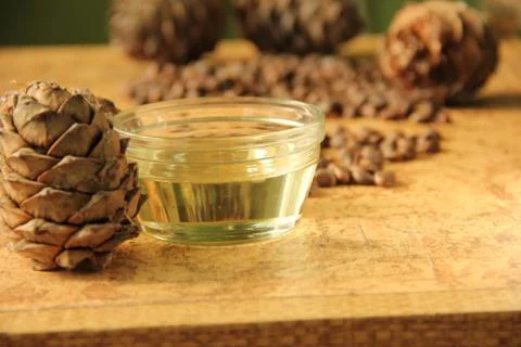 Pine nuts and bottle of essential oil Stock Photos