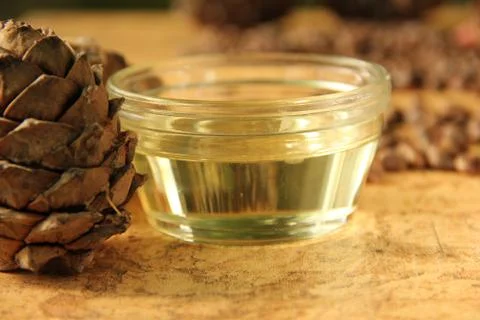 Pine nuts and bottle of essential oil Stock Photos