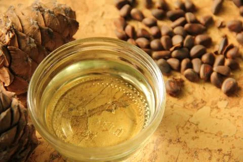 Pine nuts and bottle of essential oil Stock Photos