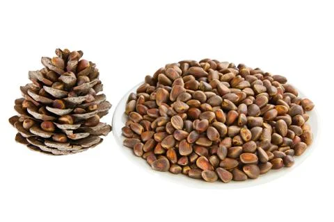 Pine nuts and pine cone on wooden table Stock Photos