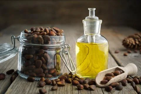 Pine nuts and pine nuts essential oil bottle. Stock Photos