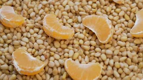 Pine Nuts and Tangerine Fruit Slices, Top View. The Concept of Healthy Vegetaria Stock Footage 142874307
