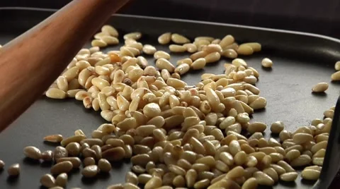 Pine nuts being roasted in a pan Video stock 8574650