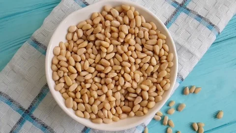 Pine nuts blue wood background Stock Footage 86704641