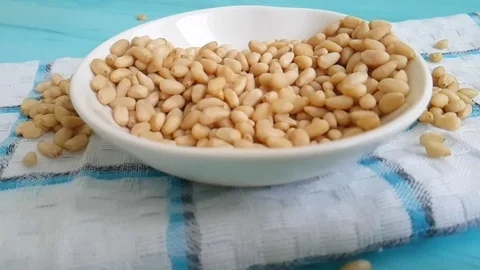 Pine nuts blue wood background fall Video stock 86704678