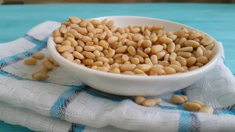 Pine nuts on a blue wooden background fall Video stock 87171824