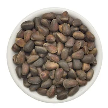 Pine nuts in a bowl isolated on white background Stock Photos
