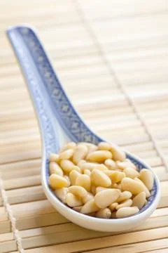 Pine nuts in ceramic spoon Stock Photos