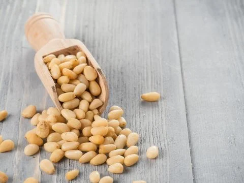 Pine nuts on gray wooden background Stock Photos