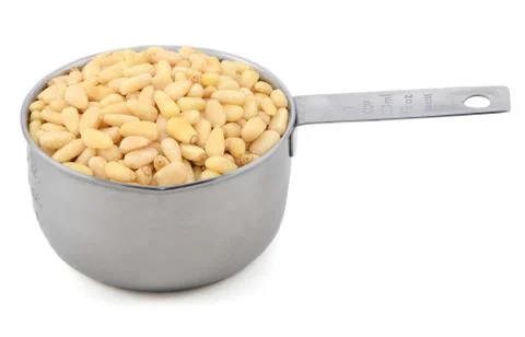 Pine nuts in a measuring cup Stock Photos