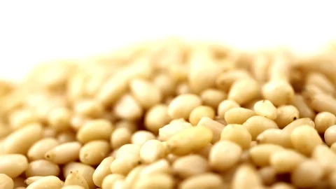 Pine nuts rotate on the surface. View from above. Colors come out of the camera. Stock Footage 94143003