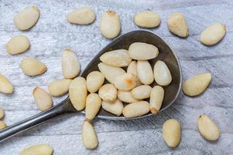 Pine nuts on a spoon macro Stock Photos