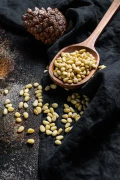 Pine nuts on stone table. Black background. Top view Foto stock