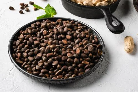 Pine nuts, on white stone table background Foto stock