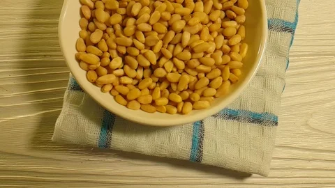 Pine nuts on a white wooden background Stock Footage 87171842