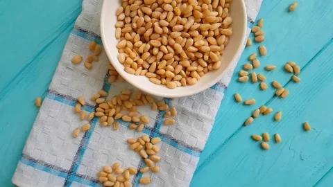 Pine nuts on a wooden background Stock Footage 87126176