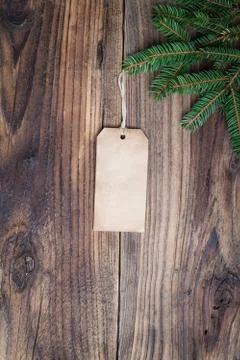 Pine tree with empty label on old wooden background Stock Photos