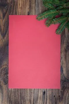 Pine tree with empty paper sheet on old wooden background Stock Photos