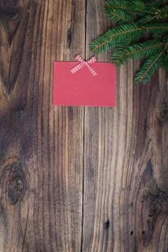 Pine tree with empty red paper sheet on old wooden background Stock Photos