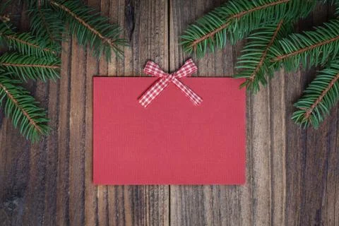 Pine tree with empty red paper sheet on old wooden background Stock Photos